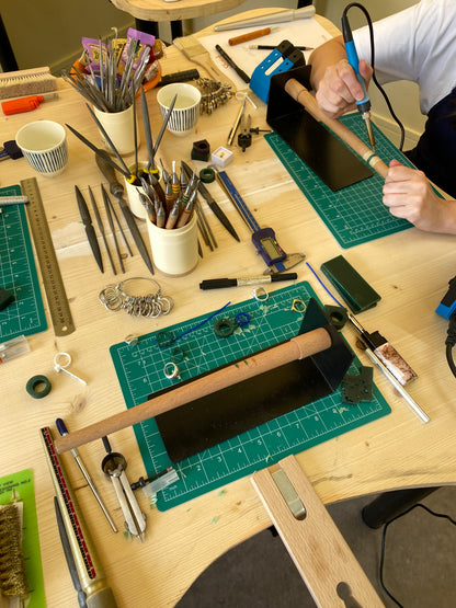 Workbench with tools and materials on a wooden surface at a jewelry workshop in antwerp
