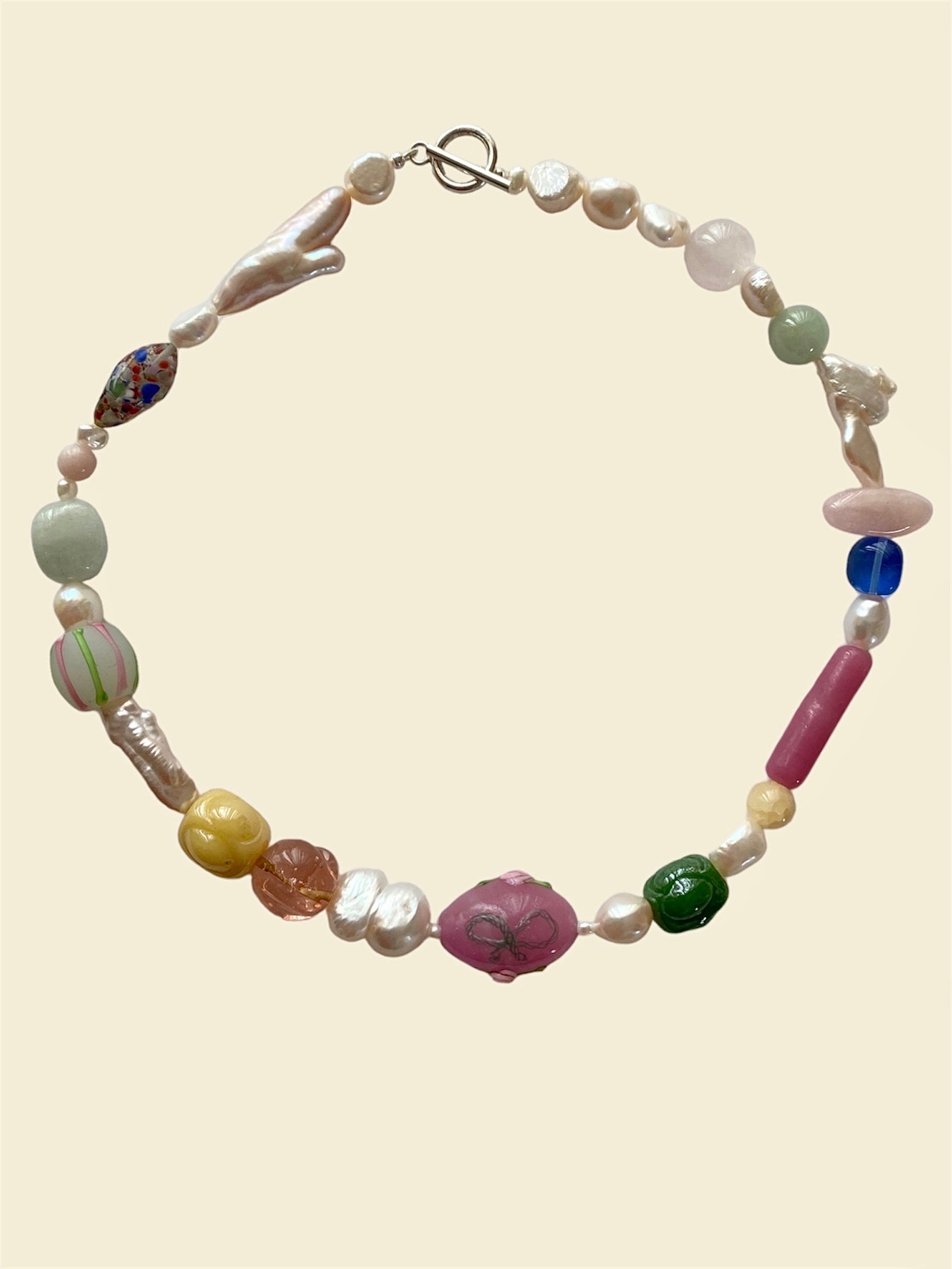 gemstone necklace with jade, opal, onyx, freshwater pearls and deadstock vintage Murano glass beads that is sourced from Italy. Henriette necklace is about the delicate balance between the soft pastel hues and the rich vibrant gemstones, hand-blown glass bead features a gorgeous all around design adorned with roses and pink bows
