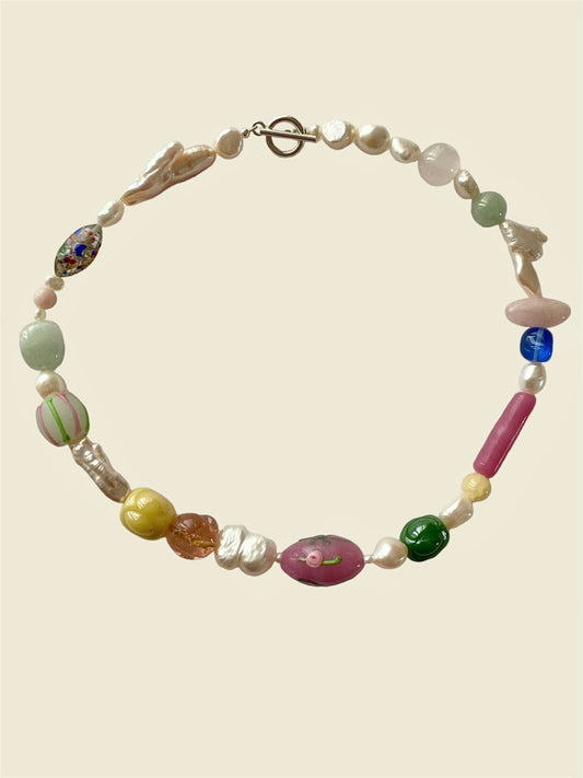 gemstone necklace with jade, opal, onyx, freshwater pearls and deadstock vintage Murano glass beads that is sourced from Italy. Henriette necklace is about the delicate balance between the soft pastel hues and the rich vibrant gemstones, hand-blown glass bead features a gorgeous all around design adorned with roses and pink bows